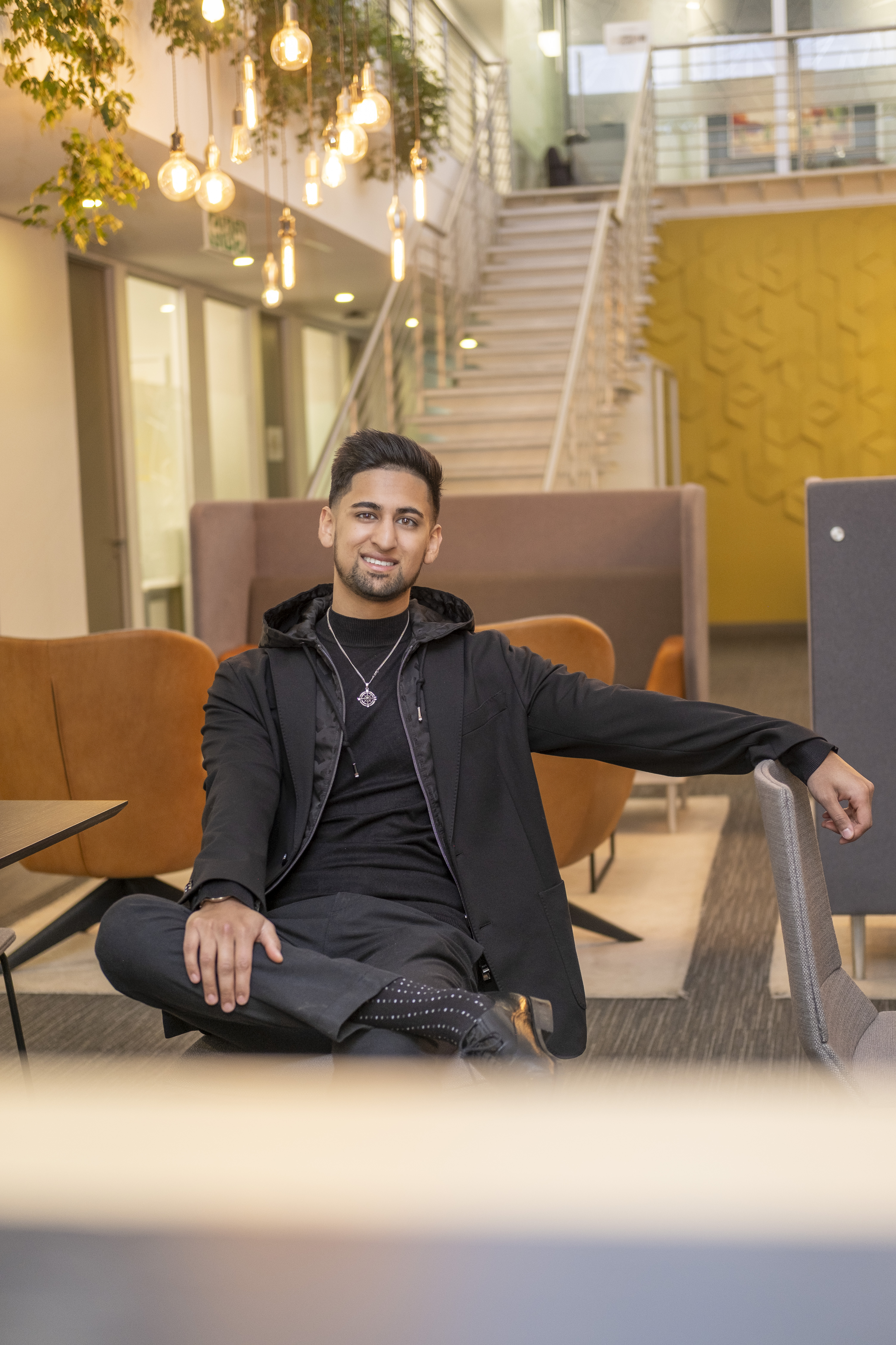 Abdullah Hassan in formal business suit with portfolio