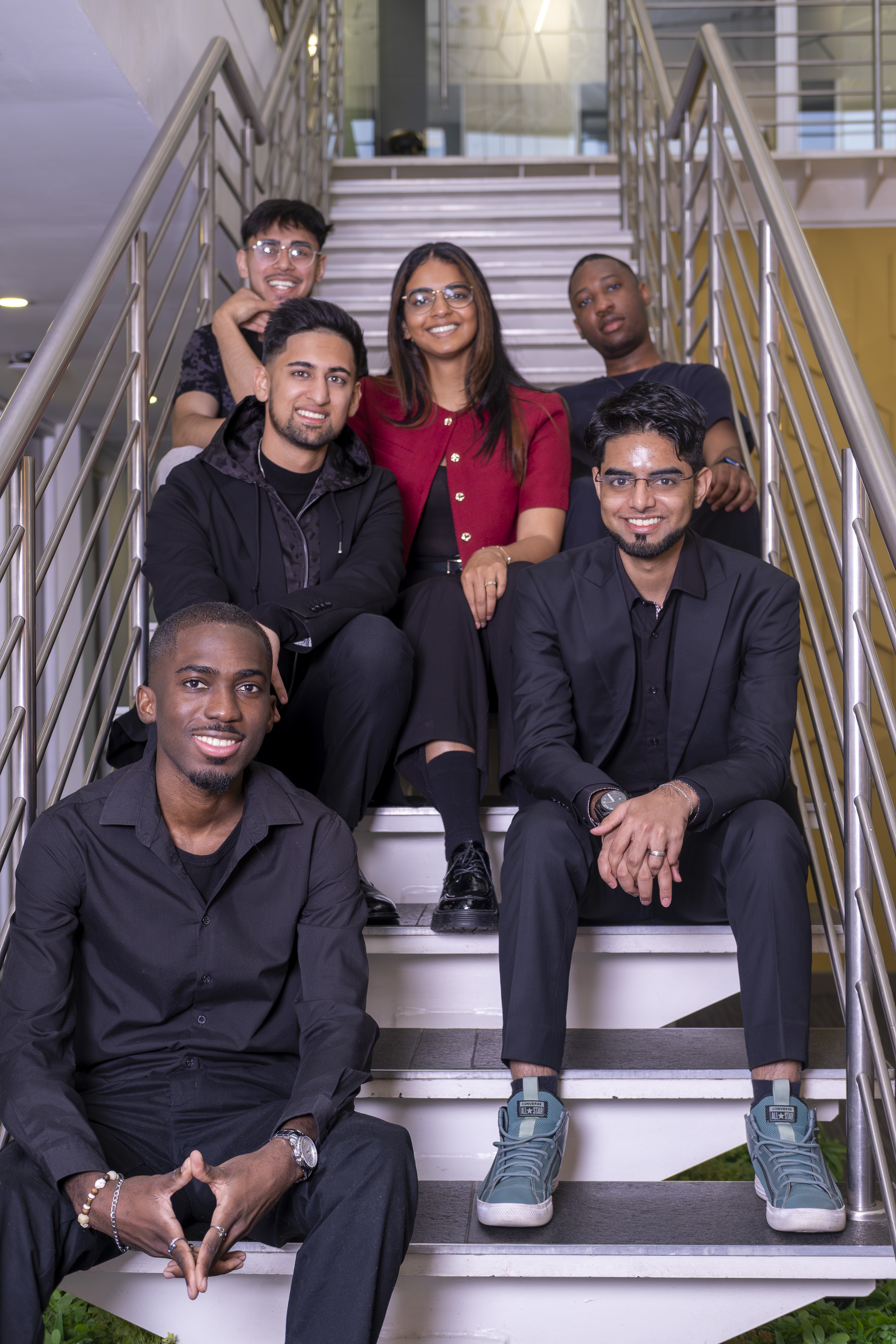 Team photo with Abdullah Hassan and colleagues on staircase